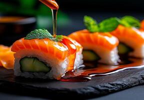 Sushi rolls with salmon, avocado, and cucumber drizzled with sauce, garnished with mint. delicious and visually appealing dish perfect for sushi lovers photo