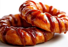 Delicious glazed donuts drizzled with sweet caramel sauce, perfect for dessert lovers. These treats are ideal for any occasion, bringing joy and satisfaction photo