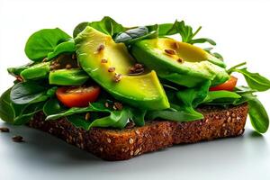 delicious whole grain bread topped with fresh avocado, spinach, and cherry tomatoes, garnished with seeds, creating healthy and vibrant meal photo