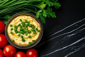 Delicious hummus topped with green onions, surrounded by fresh tomatoes and herbs, creating vibrant and appetizing display. Perfect for healthy snacking or entertaining photo