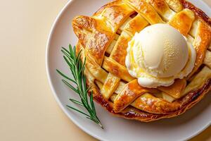 Delicious apple pie topped with creamy ice cream and sprig of rosemary, perfect for dessert lovers. golden crust and smooth ice cream create delightful treat photo