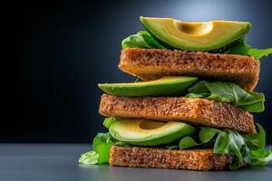stack of whole grain bread slices topped with fresh avocado and leafy greens, creating healthy and vibrant meal. contrast of colors adds visual appeal photo