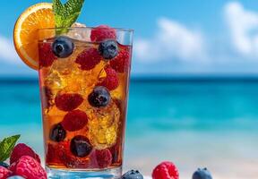 Colorful cocktail with blueberries, raspberries, and orange slice, set against beautiful beach background. Refreshing drink perfect for summer enjoyment photo