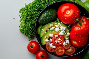Fresh salad with avocados, tomatoes, and lettuce, showcasing vibrant colors and textures. Perfect for healthy meals and garnishing dishes photo