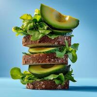 Fresh whole grain bread stacked with avocado and leafy greens, showcasing healthy and vibrant meal option. bright colors and textures create appealing visual for nutritious eating photo