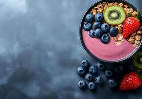 vibrant smoothie bowl featuring blueberries, kiwi, strawberries, and granola, perfect for healthy breakfast or snack. colorful presentation evokes freshness and vitality photo