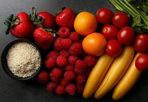 Fresh fruits and healthy ingredients including strawberries, raspberries, oranges, cherry tomatoes, bananas, and rice create vibrant and nutritious display photo