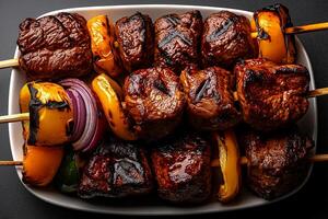 Grilled meat skewers with colorful vegetables on white platter, showcasing delicious and appetizing arrangement. Perfect for gatherings and barbecues photo
