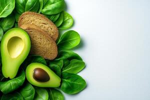 Fresh avocado halves on bed of green leaves with slices of whole grain bread, creating healthy and vibrant composition. Perfect for food lovers and healthy eating enthusiasts photo