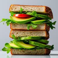 stack of whole grain sandwiches filled with fresh avocado, tomato, and leafy greens, showcasing healthy and vibrant meal option photo