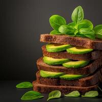 stack of sliced brown bread layered with fresh avocado and basil leaves, creating healthy and appetizing look. Perfect for nutritious meal or snack photo