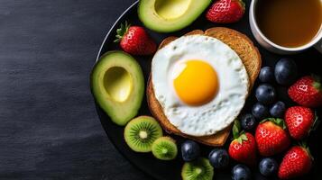 healthy breakfast plate featuring toast with fried egg, fresh strawberries, blueberries, avocado halves, and cup of coffee. Enjoy nutritious start to your day photo