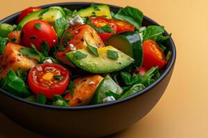 Fresh salad with avocado, tomatoes, and greens, garnished with herbs and cheese, perfect for healthy meal photo