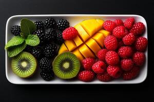 Fresh fruit platter featuring mango, kiwi, blackberries, and raspberries, beautifully arranged for vibrant and healthy snack. Perfect for summer gatherings or nutritious breakfast photo