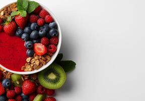 vibrant smoothie bowl topped with fresh berries, granola, and mint. This colorful dish features strawberries, blueberries, raspberries, and kiwi, perfect for healthy breakfast or snack photo