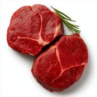 Fresh raw beef steaks with sprig of rosemary, perfect for grilling or cooking. These cuts showcase rich red color and marbling, ideal for meat lovers photo