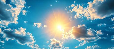 Bright sun shining through fluffy clouds in clear blue sky, creating vibrant and uplifting atmosphere photo