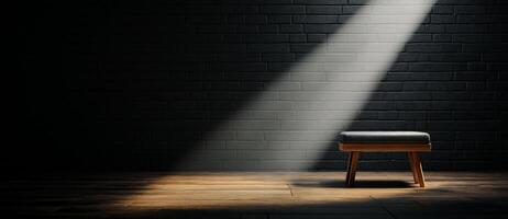 minimalist room featuring single stool illuminated by beam of light, creating dramatic contrast with dark walls and floor. atmosphere evokes sense of solitude and contemplation photo