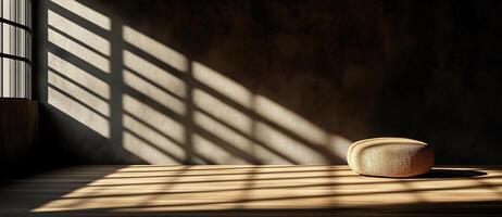minimalist interior scene featuring concrete walls and soft shadows. warm light creates serene atmosphere, highlighting round, textured pouf on wooden floor photo