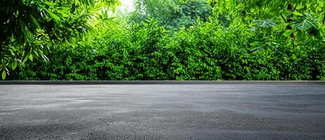 serene concrete surface with lush green foliage in background, creating peaceful outdoor setting. Ideal for showcasing nature and urban elements together photo