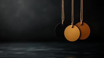 Elegant round tags in black and gold hanging on strings, perfect for branding or gift labeling. minimalist design adds touch of sophistication to any presentation photo