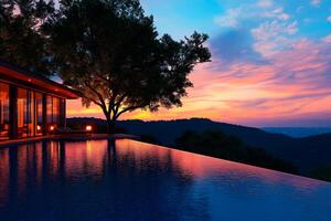 modern luxury villa with stunning infinity pool reflecting vibrant sunset. serene landscape features lush hills and tranquil atmosphere, perfect for relaxation photo