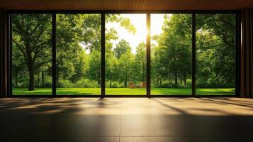 spacious interior with large windows showcasing lush green landscape. Sunlight filters through trees, creating serene and inviting atmosphere photo