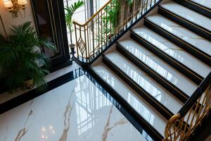 Luxurious hotel lobby with elegant staircase and polished marble floor. interior features lush greenery and sophisticated design elements, creating welcoming atmosphere photo