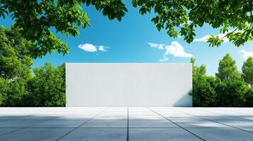 blank wall stands on empty concrete floor, surrounded by lush greenery and bright blue sky. scene evokes sense of tranquility and openness, perfect for creative projects photo