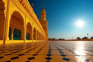 stunning view of golden palace courtyard under clear blue sky, showcasing intricate architecture and vibrant patterns on floor. sunlight casts beautiful shadows, enhancing grandeur of scene photo