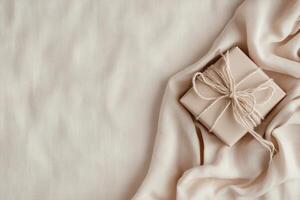 Soft linen fabric serves as the backdrop for elegantly wrapped Father's Day gifts, creating a minimalist, serene composition perfect for expressing love and appreciation photo