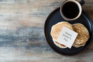 Enjoy a delightful breakfast featuring fluffy pancakes and coffee, accompanied by a cheerful note, set on a rustic wooden table bathed in soft morning light photo