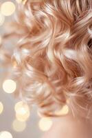 Close-up view capturing the beauty of healthy, defined natural curls being hydrated with a nourishing mist. A soft-focus background creates a warm, radiant aesthetic photo