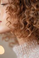 Defined natural curls receive hydration from a nourishing mist, showcasing healthy hair in a soft-focus background enriched with warm golden bokeh for a glowing aesthetic photo