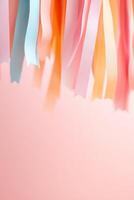 Brightly colored streamers hang in front of a soft sunset sky, featuring warm pink and orange shades. This lively setting creates a perfect atmosphere for celebrations and events photo