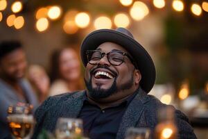 Surrounded by friends, a joyful overweight man shares laughter during an elegant rooftop dinner party. The warm atmosphere, enhanced by string lights, creates a luxurious setting for connection photo