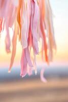 Colorful streamers dangle in the foreground, capturing the essence of a lively carnival amidst a warm pink and orange sunset sky, ideal for festive celebrations and events photo