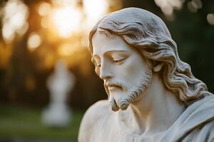 A meticulously crafted Jesus statue bathed in gentle sunlight. Trees blur in the background, focusing on the peaceful expression of the statue, fostering a sense of calm spirituality photo