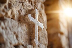 Soft-focus light streams from above, highlighting a carved cross on an ancient stone church wall. This sacred symbol evokes a sense of history and reverence in its warm ambiance photo