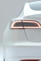 A close-up view of a modern electric vehicle highlights its elegant rear lights and streamlined body. The setting emphasizes simplicity and sophistication, capturing attention effortlessly photo