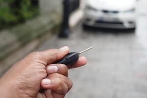 Unlocking a car using a remote key in an urban area photo