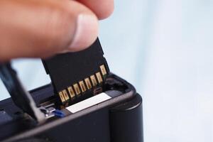 Inserting memory card into electronic device for data storage photo