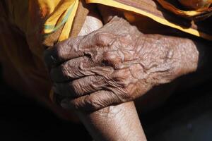 Elderly hands intertwined, expressing care and connection photo