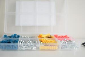Assorted screws and fasteners neatly arranged in a storage container photo
