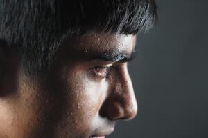 Young person in profile with focused expression and subtle lighting photo