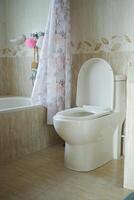 Clean bathroom with modern toilet and bathtub design in soft colors photo