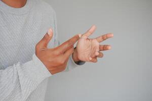Hands gesturing in a creative expression against a simple backdrop photo