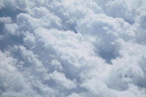 Bright white clouds fill the sky on a sunny day in summer photo