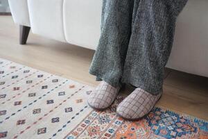 Cozy indoor setup with relaxed feet on a soft rug photo