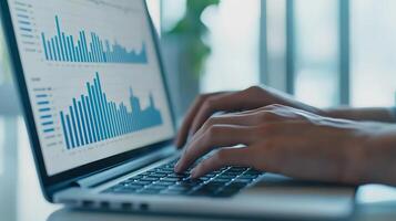 A person is typing on a laptop displaying data visualizations, showcasing graphs and statistics in a modern workspace. photo